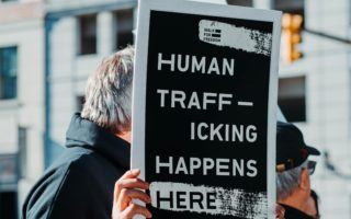 human-trafficking-sign-protest